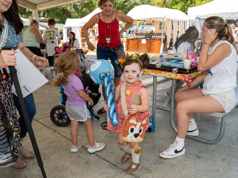 little girl with balloon art